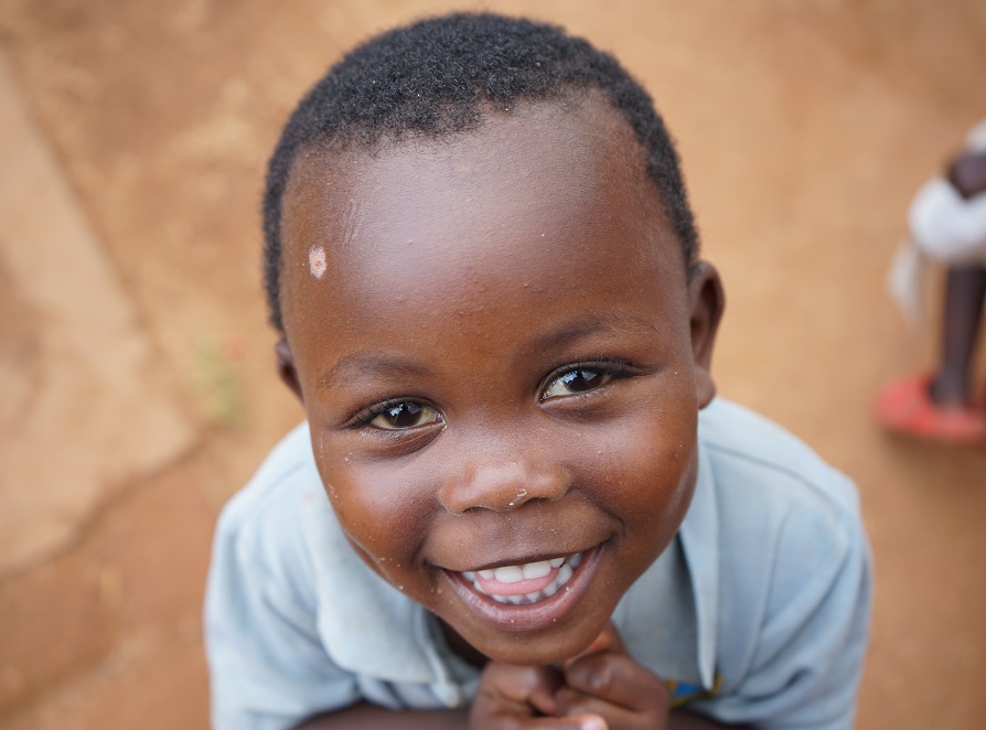 A child in Uganda smiles.