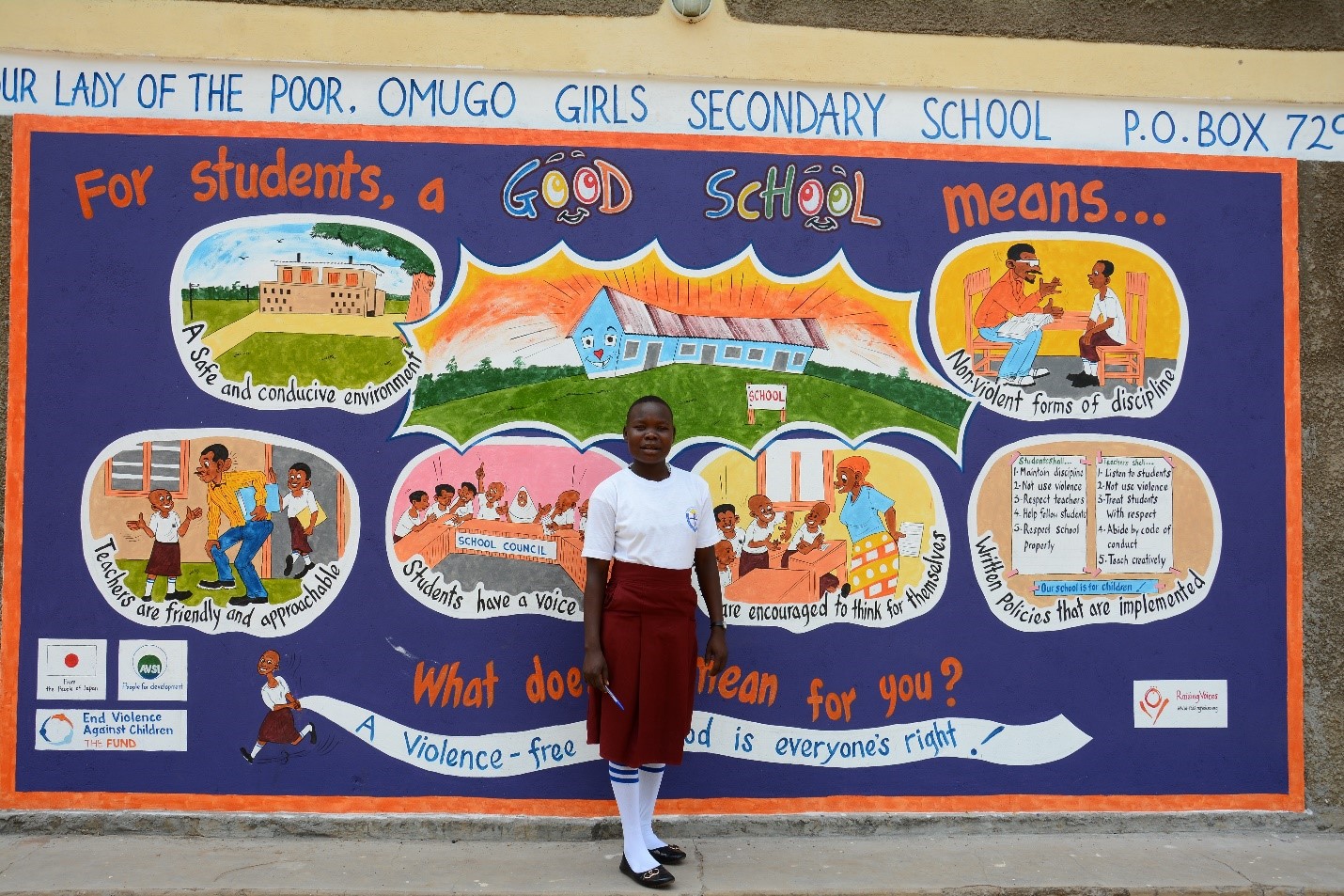 A child stands in front of an art mural created by her community as part of the Good School Toolkit programme in northern Uganda.
