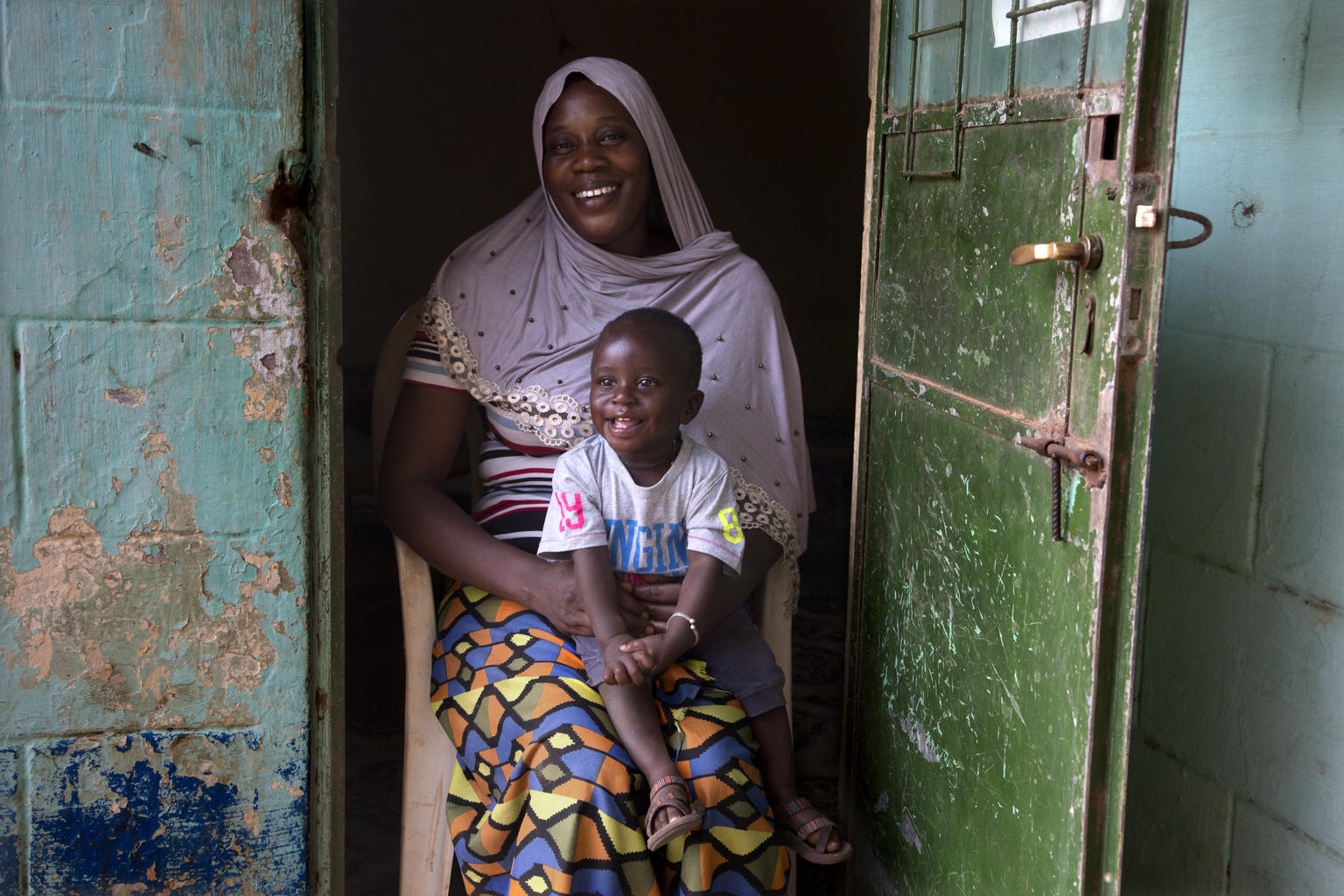 A mother holds her son in rural Soma, an area in central Gambia.