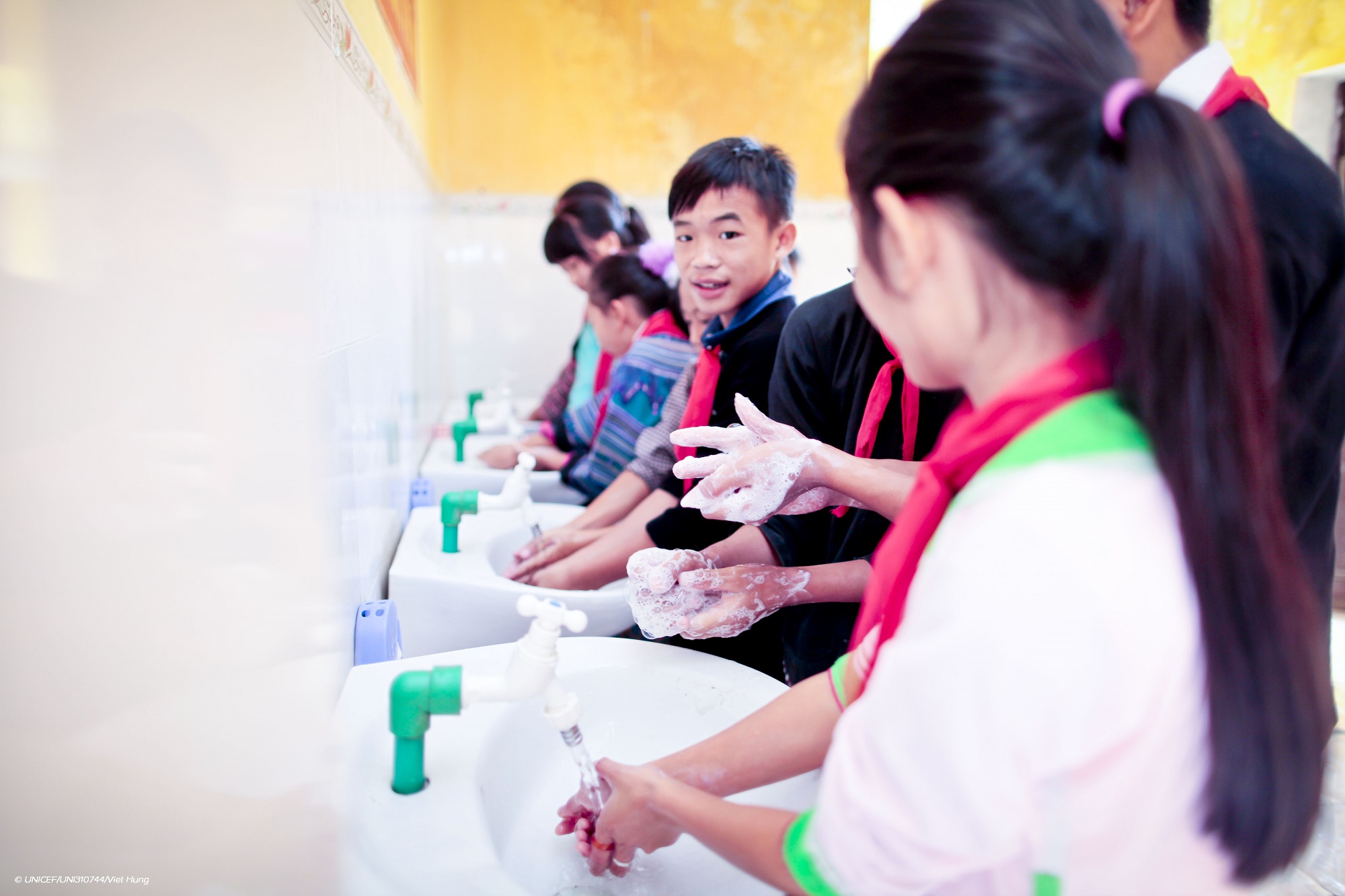 Children wash their hands.