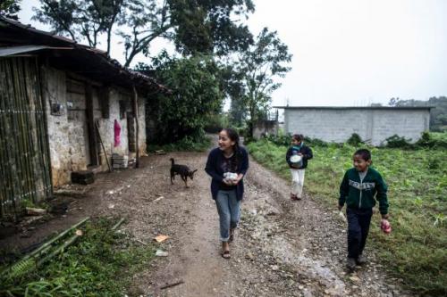Children walk down the road in Mexico.