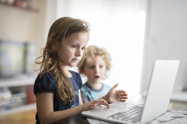 Children in Montenegro look at a computer.