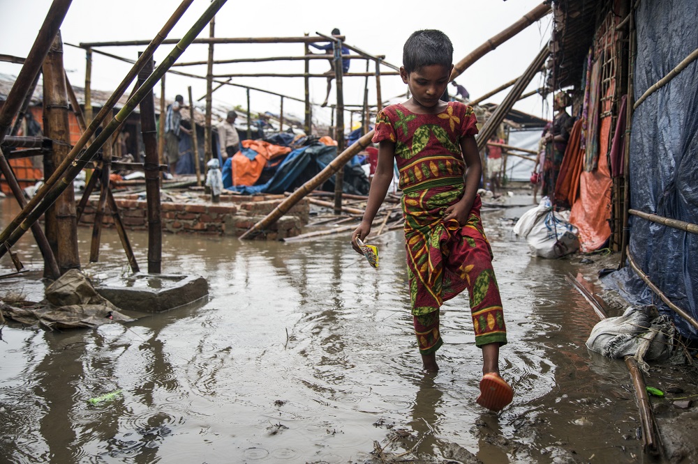 A child steps in floodwaters in Bangladesh.