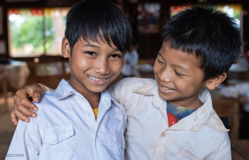 Children in Cambodia smile.