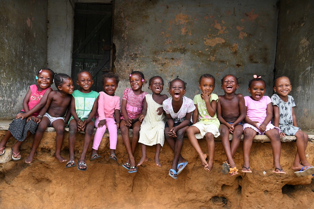 A group of children laugh in Cote D’Ivoire. 