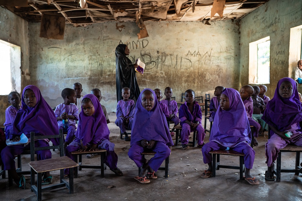 A group of children sit in a Nigerian classroom.