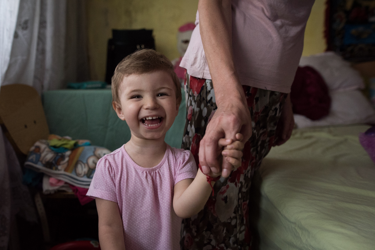 A young girl laughs in Romania.