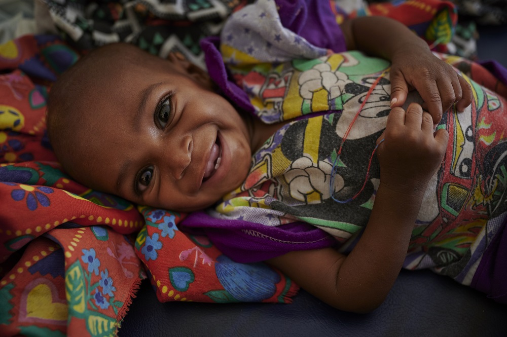 A child smiles in Sudan.