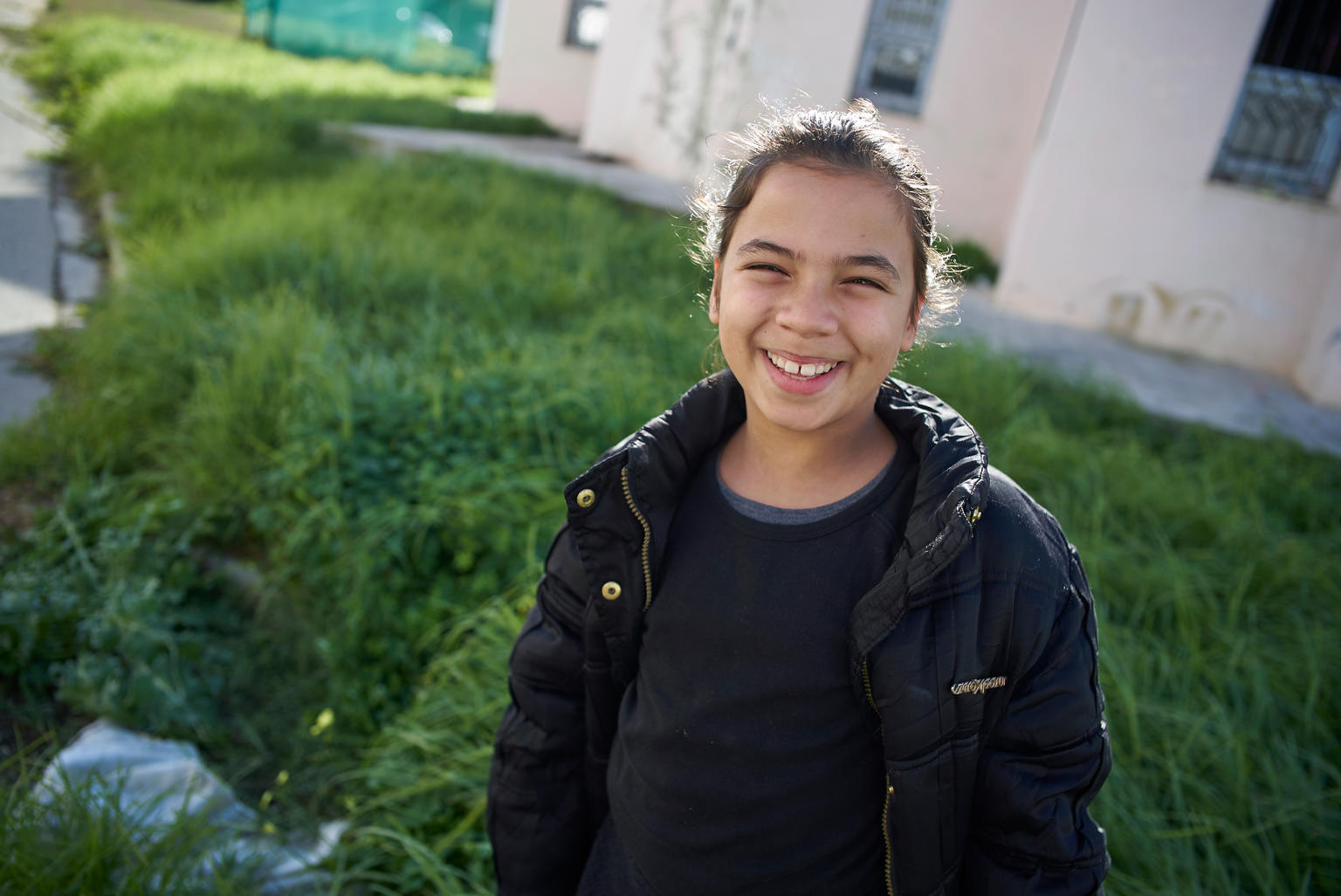 A girl in Tunisia smiles.