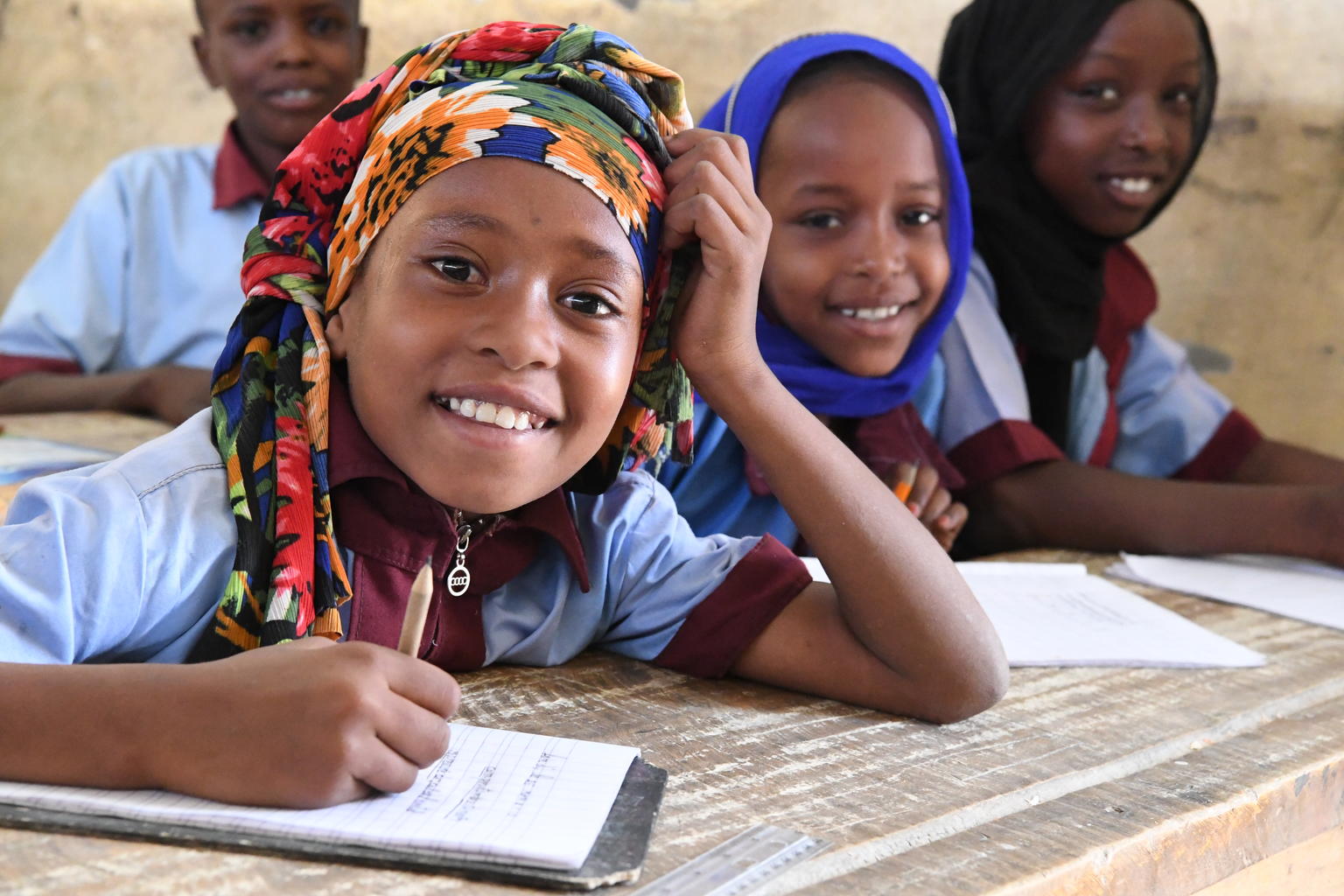 Children smile in a classroom in Chad.