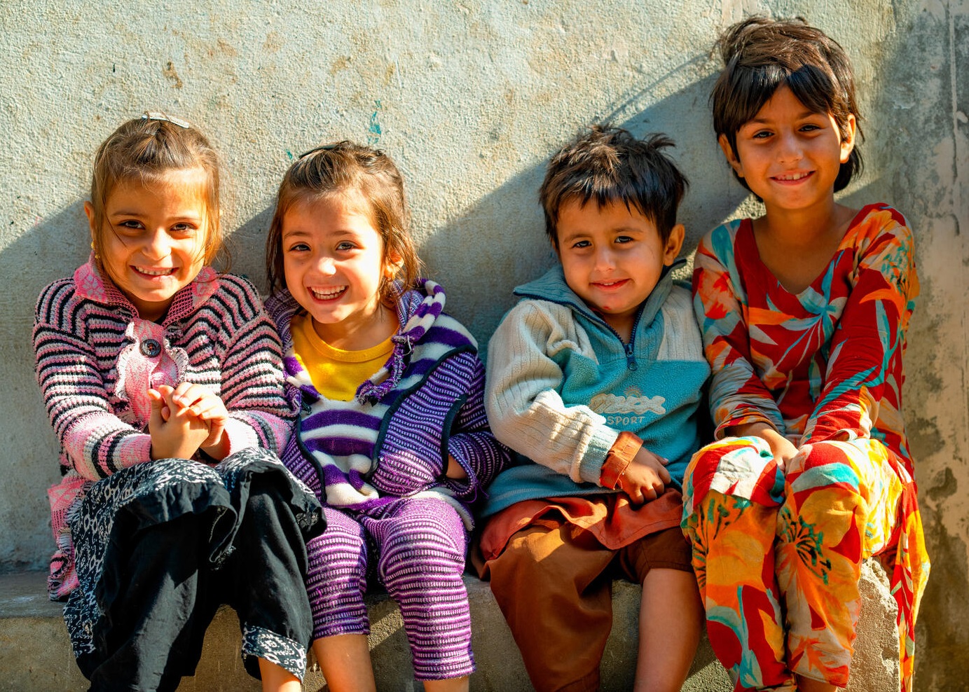 Children smile in Pakistan.