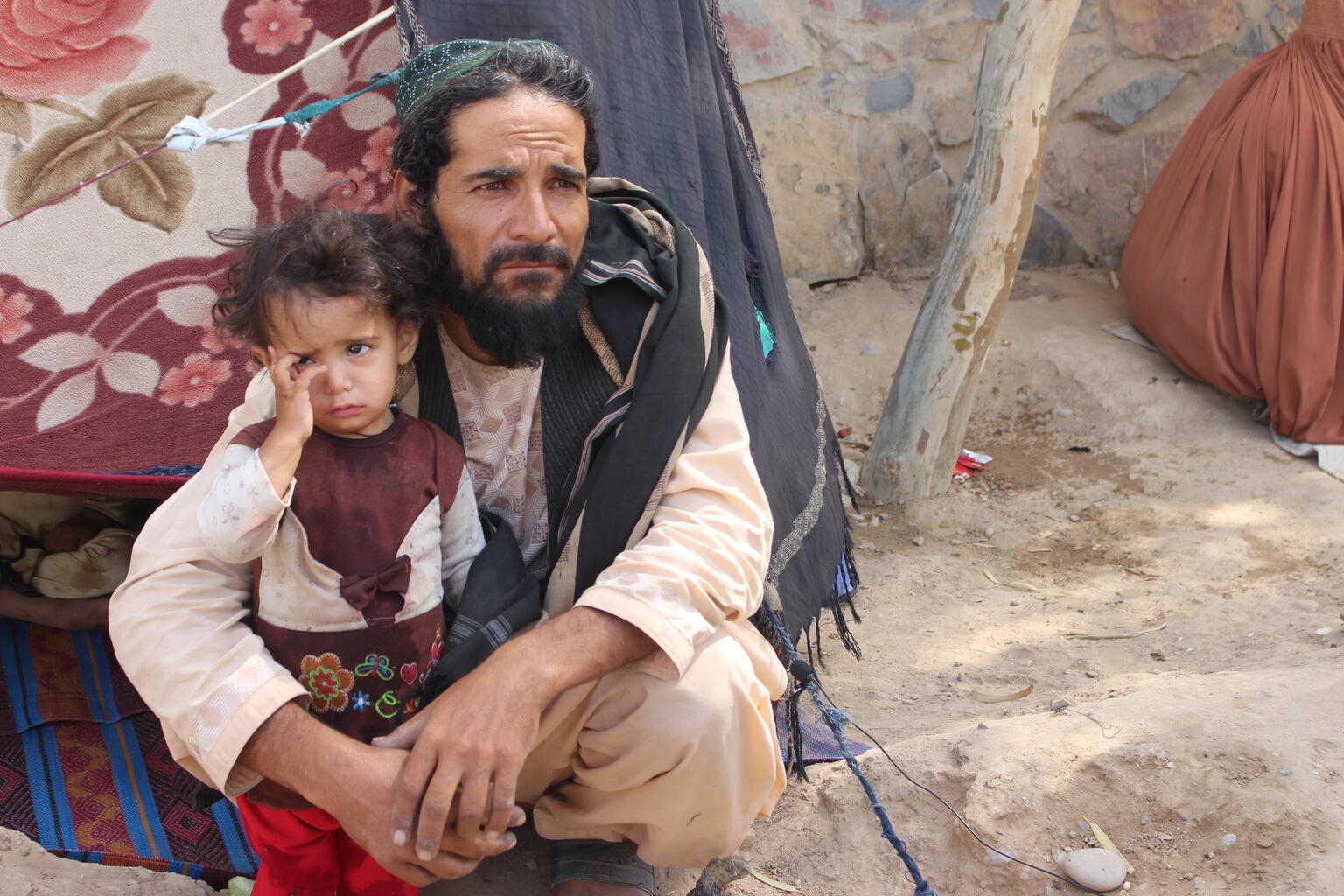 A child and her father in Afghanistan.