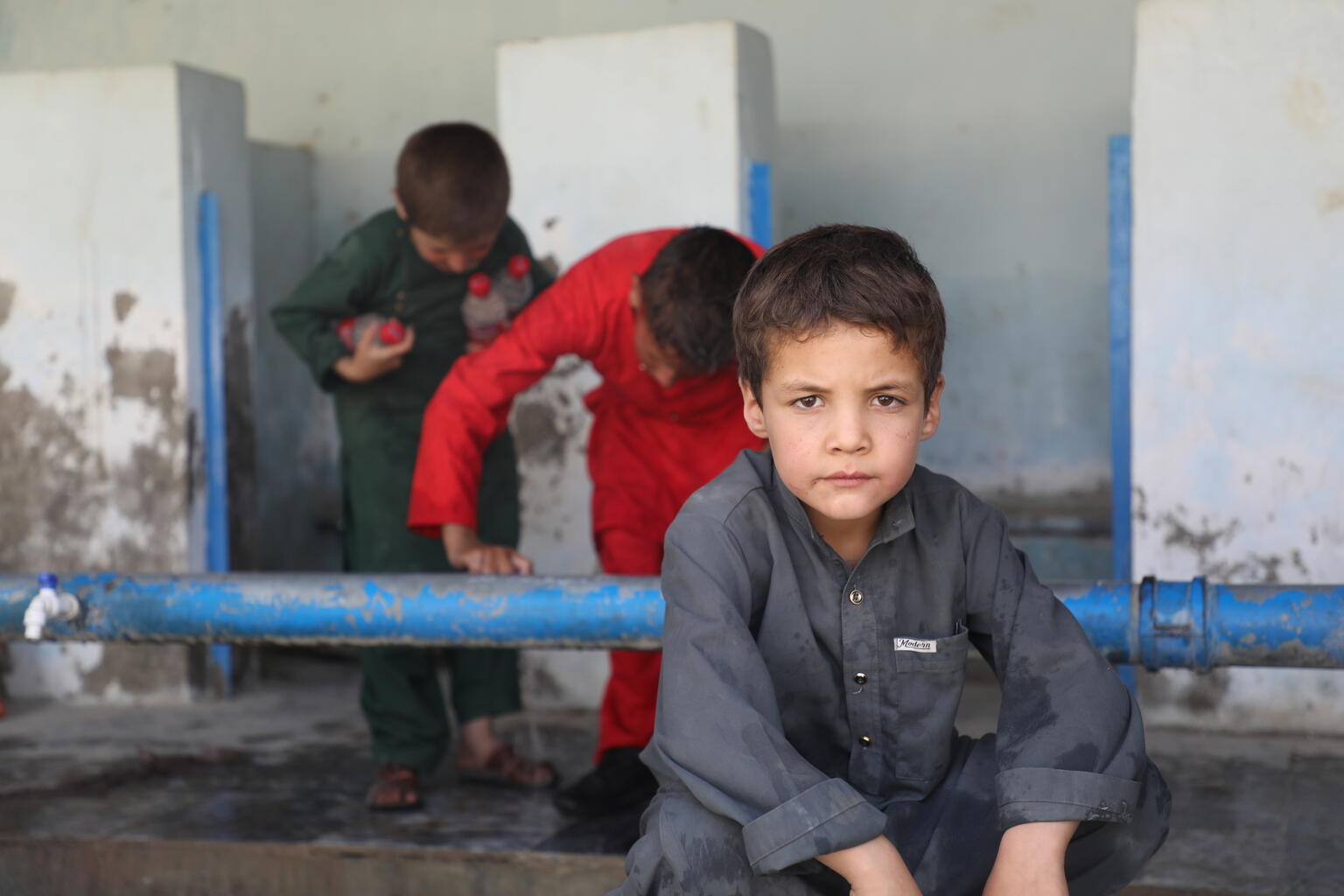 A child is pictured in Afghanistan after he and his family fled their homes amidst escalating conflict.
