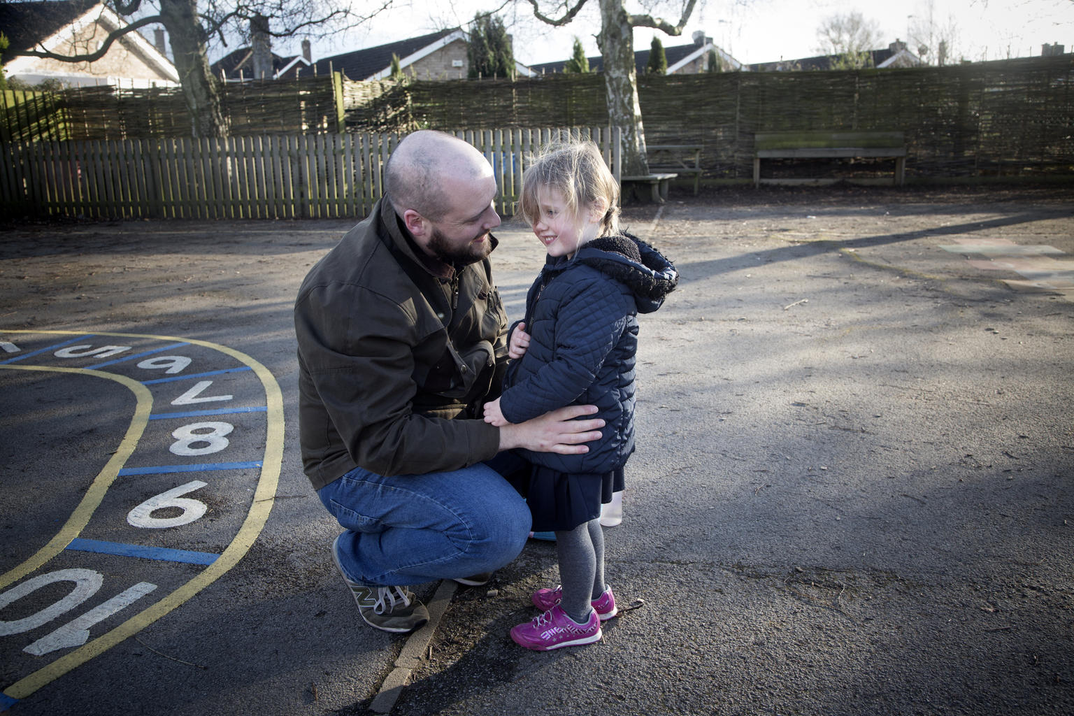 A child and her father talk in the United Kingdom.