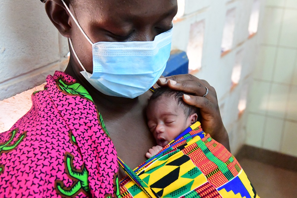 Pictured above: a mother holds her newborn child in Côte d'Ivoire. UNICEF/UNI325619/Frank Dejongh