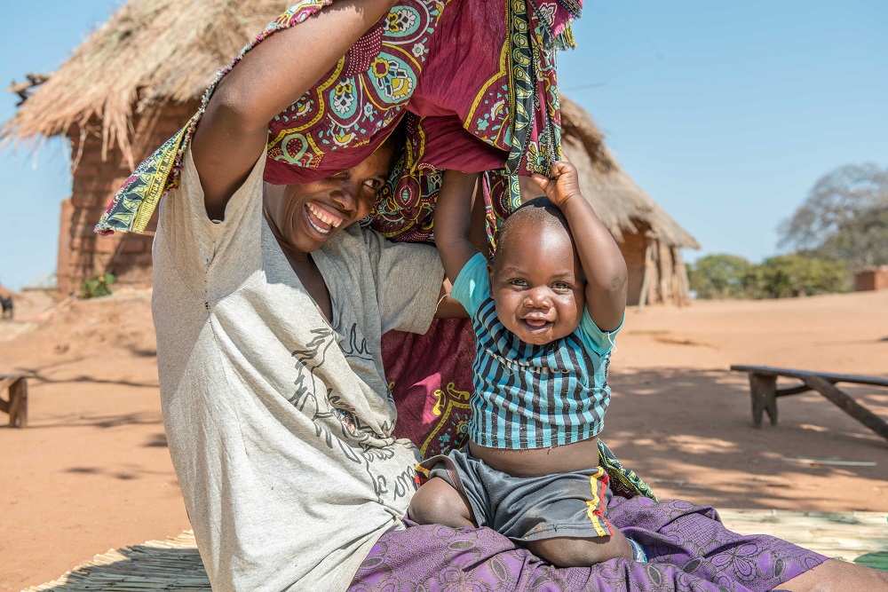 A child and his mother laugh in Zambia.