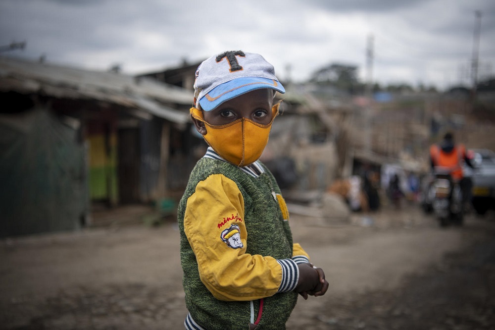 A child in Kenya wears a mask.