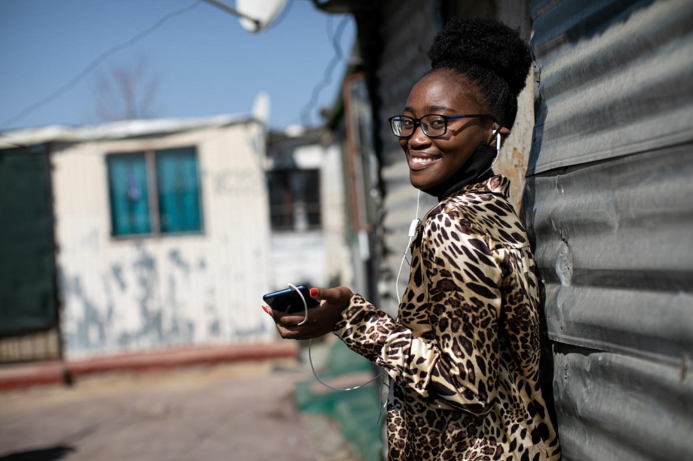 A girl uses her phone in South Africa.