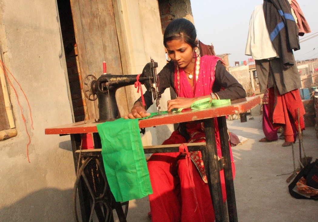 Kajal, an 18-year-old from Nepal, sews.